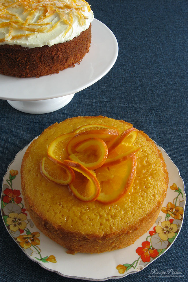 Image showing orange juice cakes, one decorated with caramelized orange slices, and another with crystallized orange peel. 