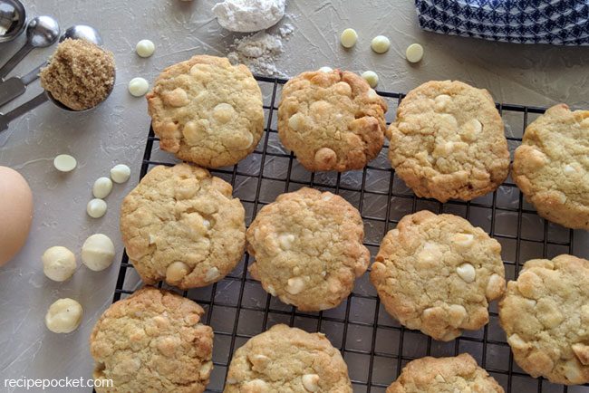 White chocolate chip macadamia nut cookies on a cooling rack.