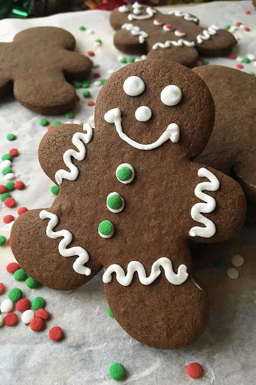 A gingerbread man cookie with white icing.