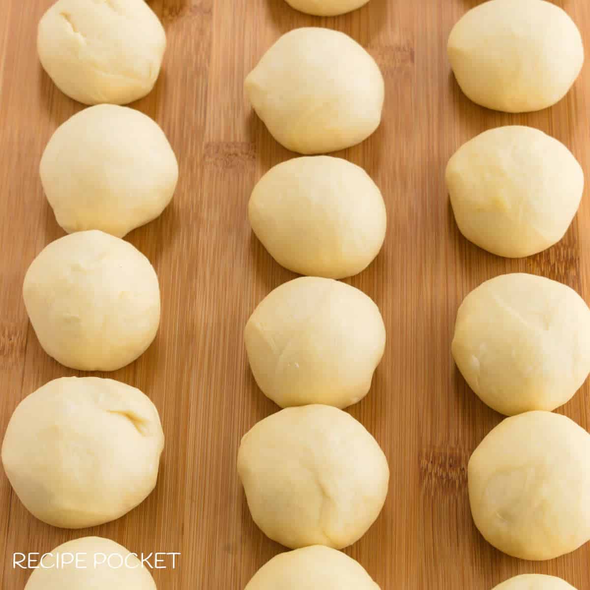 Dough balls on a board.