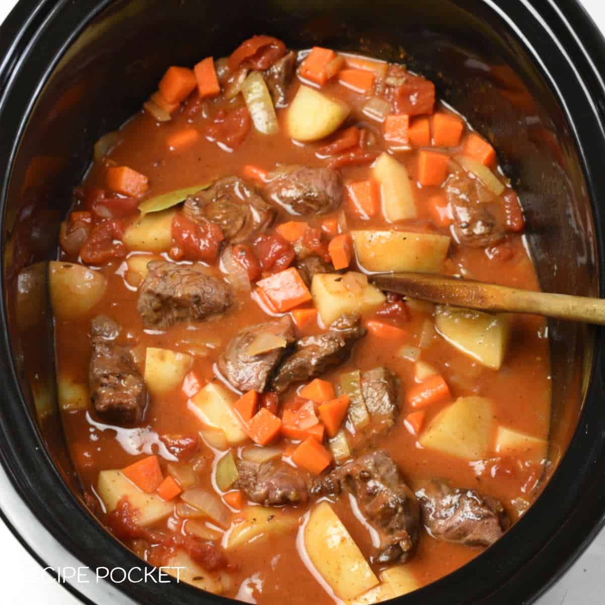 Prepared Hungarian goulash mixture in a slow cooker bowl.