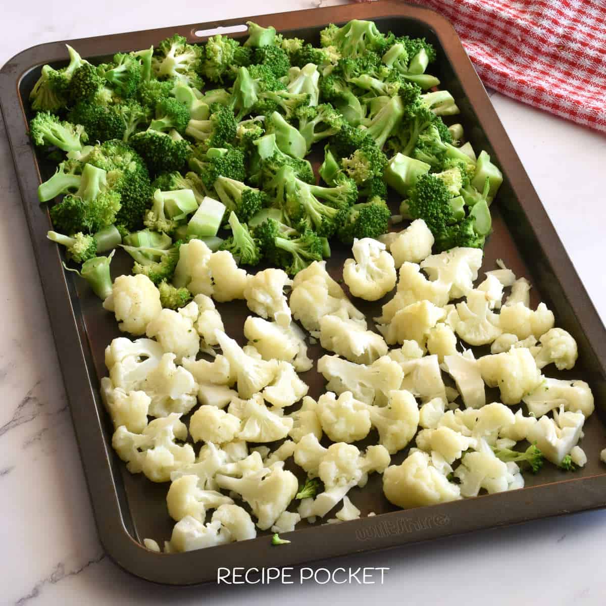 Broccoli and cauilflower pieces on a tray.
