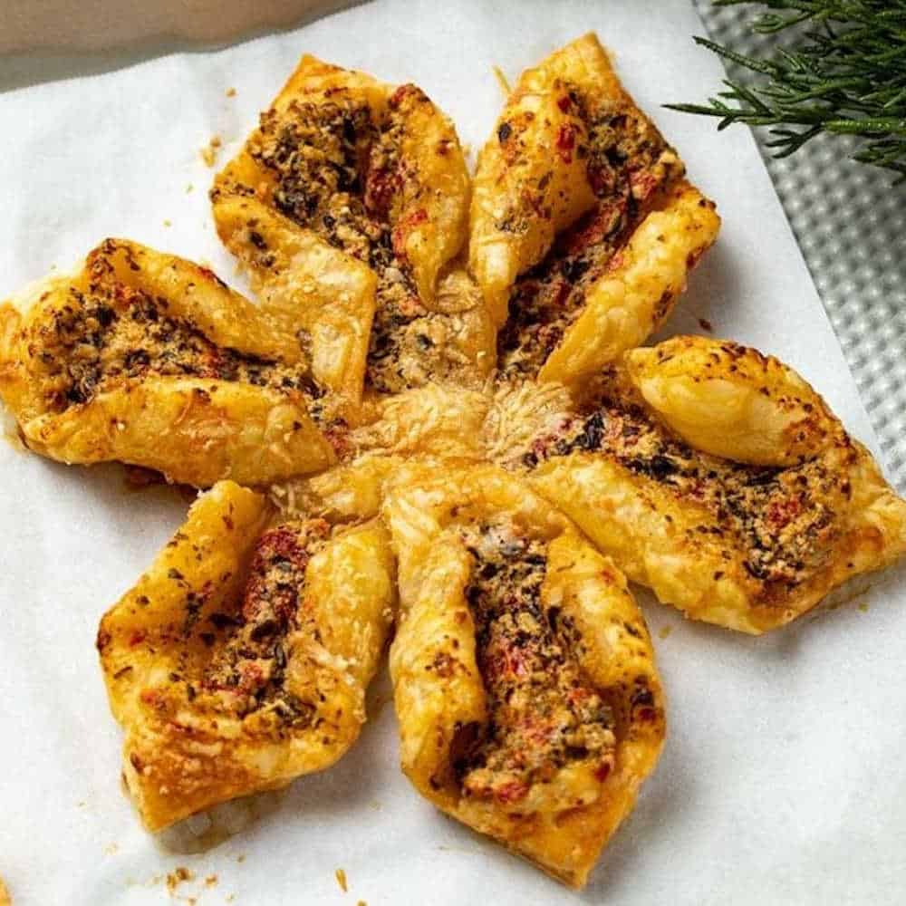 Pesto and goats cheese pastry shaped like a snowflake.