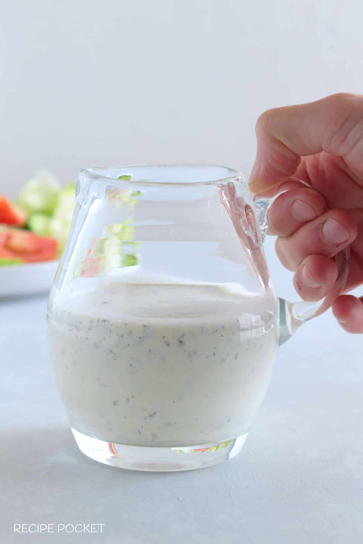 Ranch dressing made with dry ranch dressing mix in a glass jug.