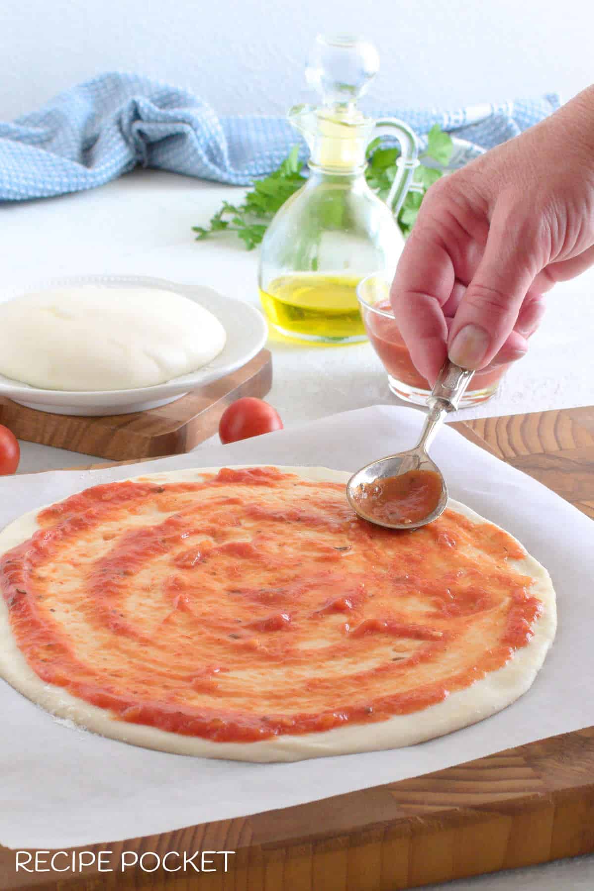 Pizza dough with sauce on top.