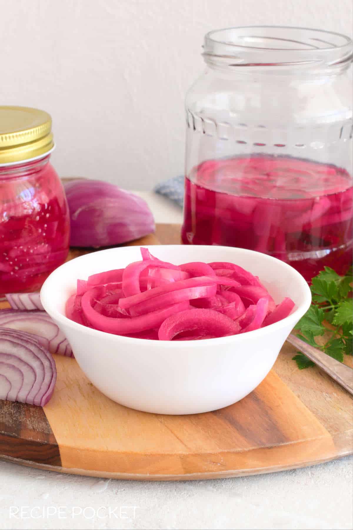 Two bottles of pickled pink onions.