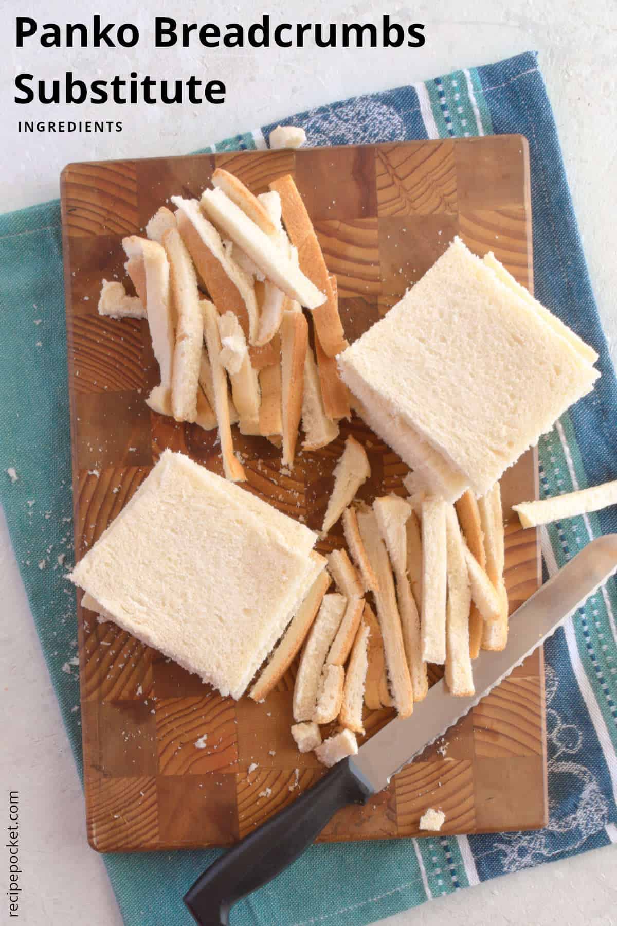Sliced white bread with crusts removed on a wooden cutting board/