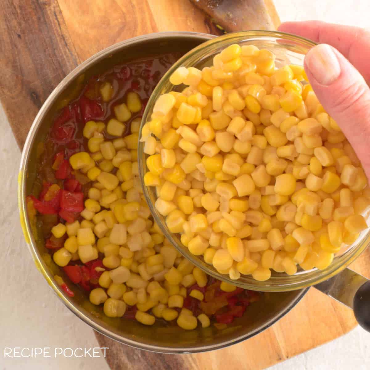 Sweet corn being added a pot.