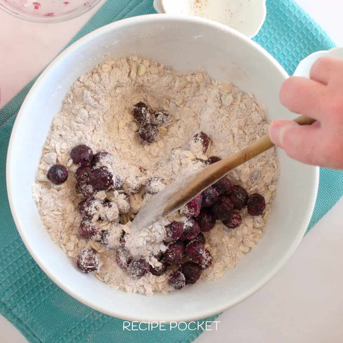 Blueberries in a bowl with flour.