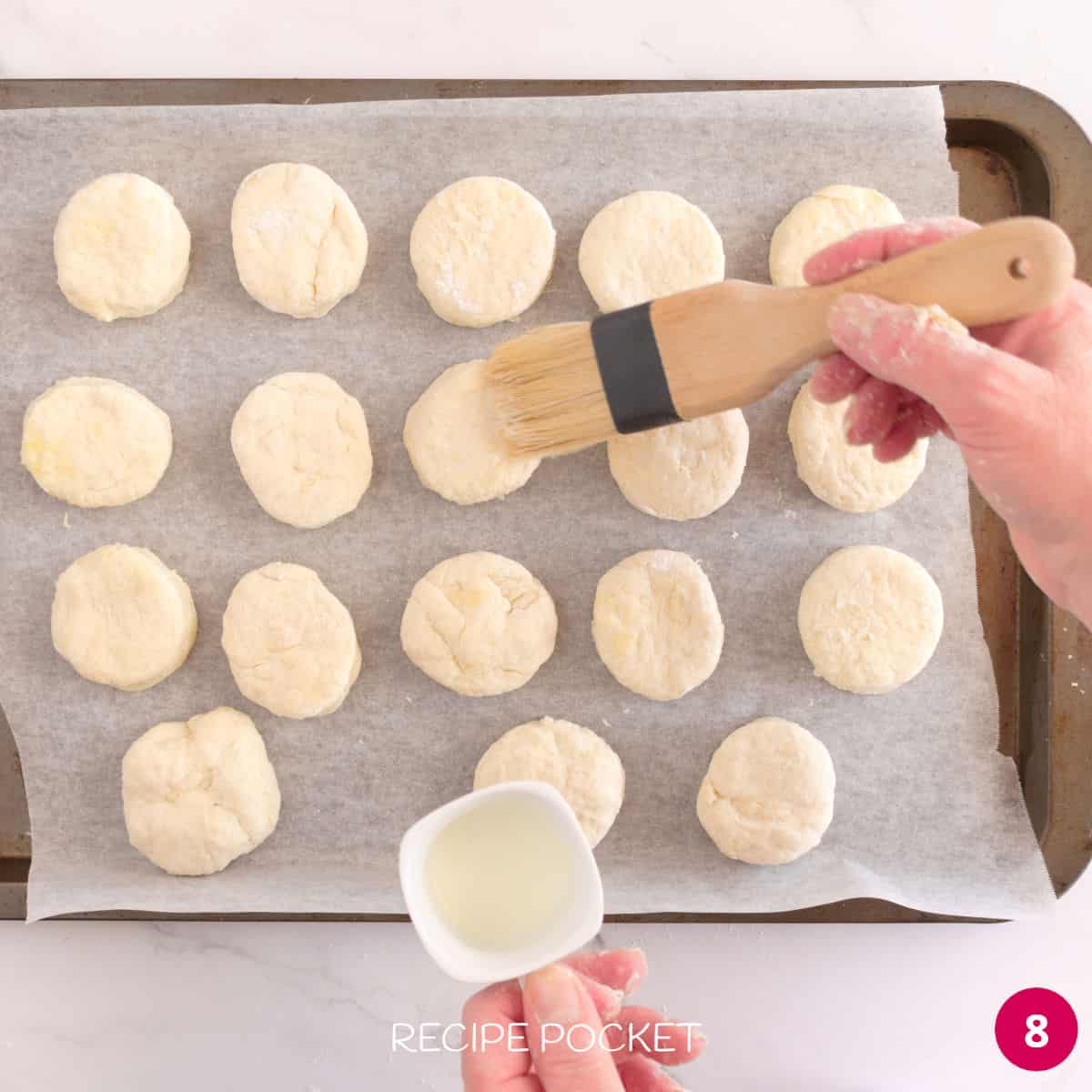 Brushing scone dough with milk.