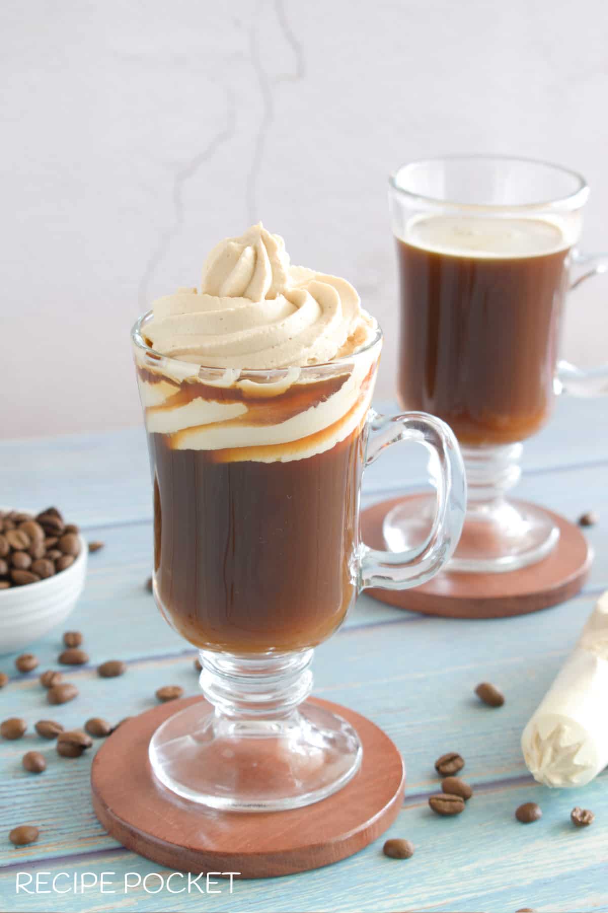 Coffee in a glass with whipped cream.