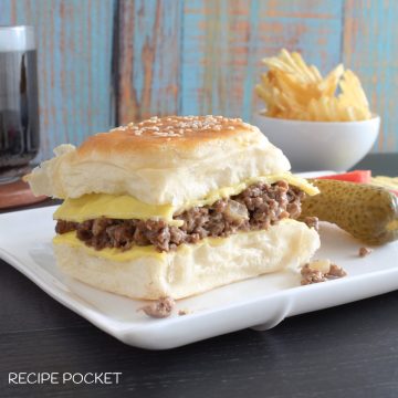 A ground beef burger on a plate.