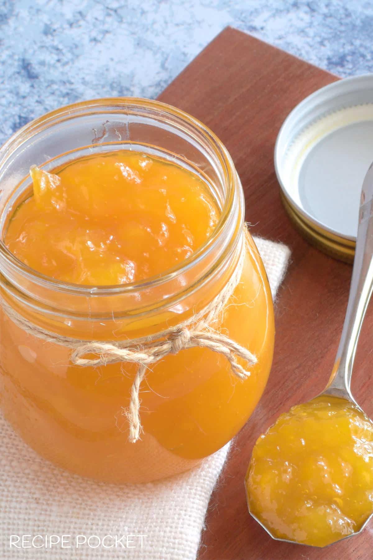 Mango jam in a glass storage jar.