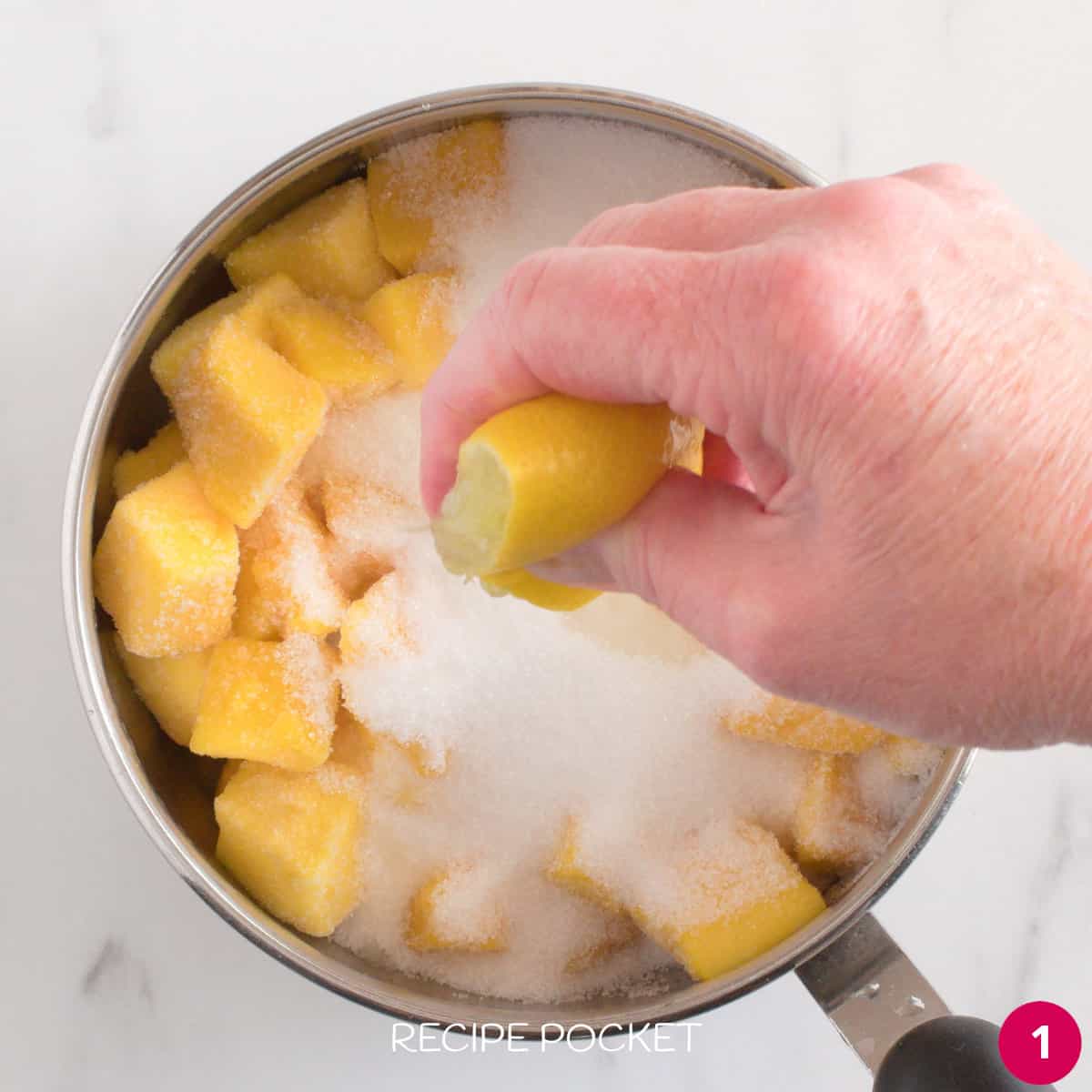 Mango pieces, sugar and lemon juice in a saucepan.
